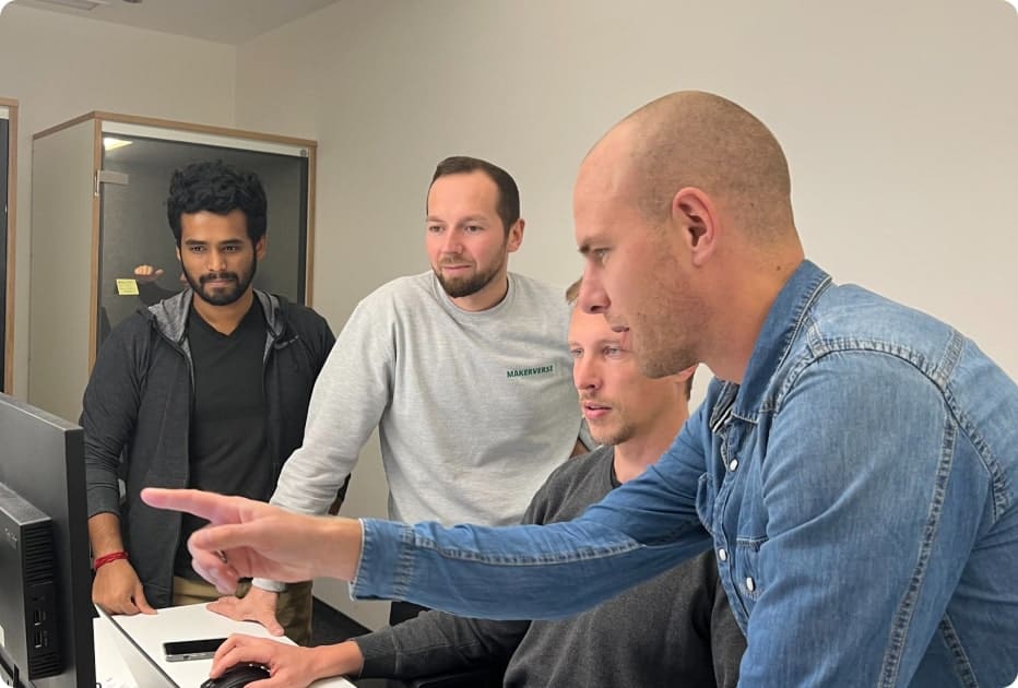 Operations team working together around computer